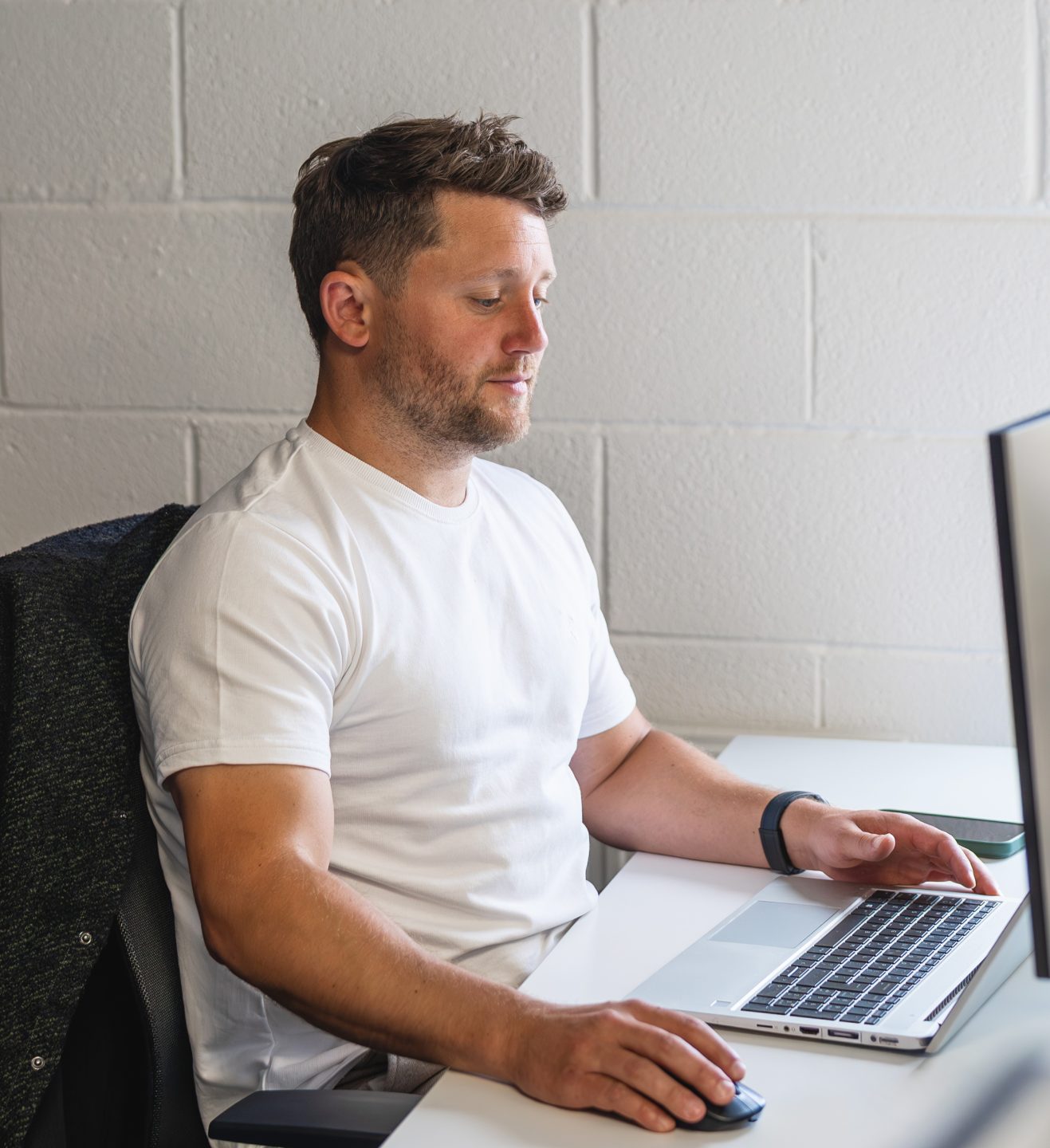 A person is working on their computer at their desk.
