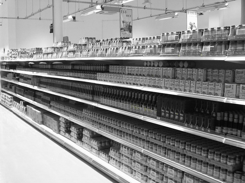 A grocery store aisle filled with various canned goods