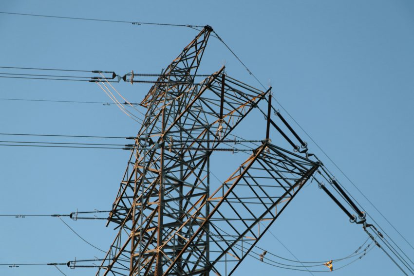 An electric tower against a a blue sky