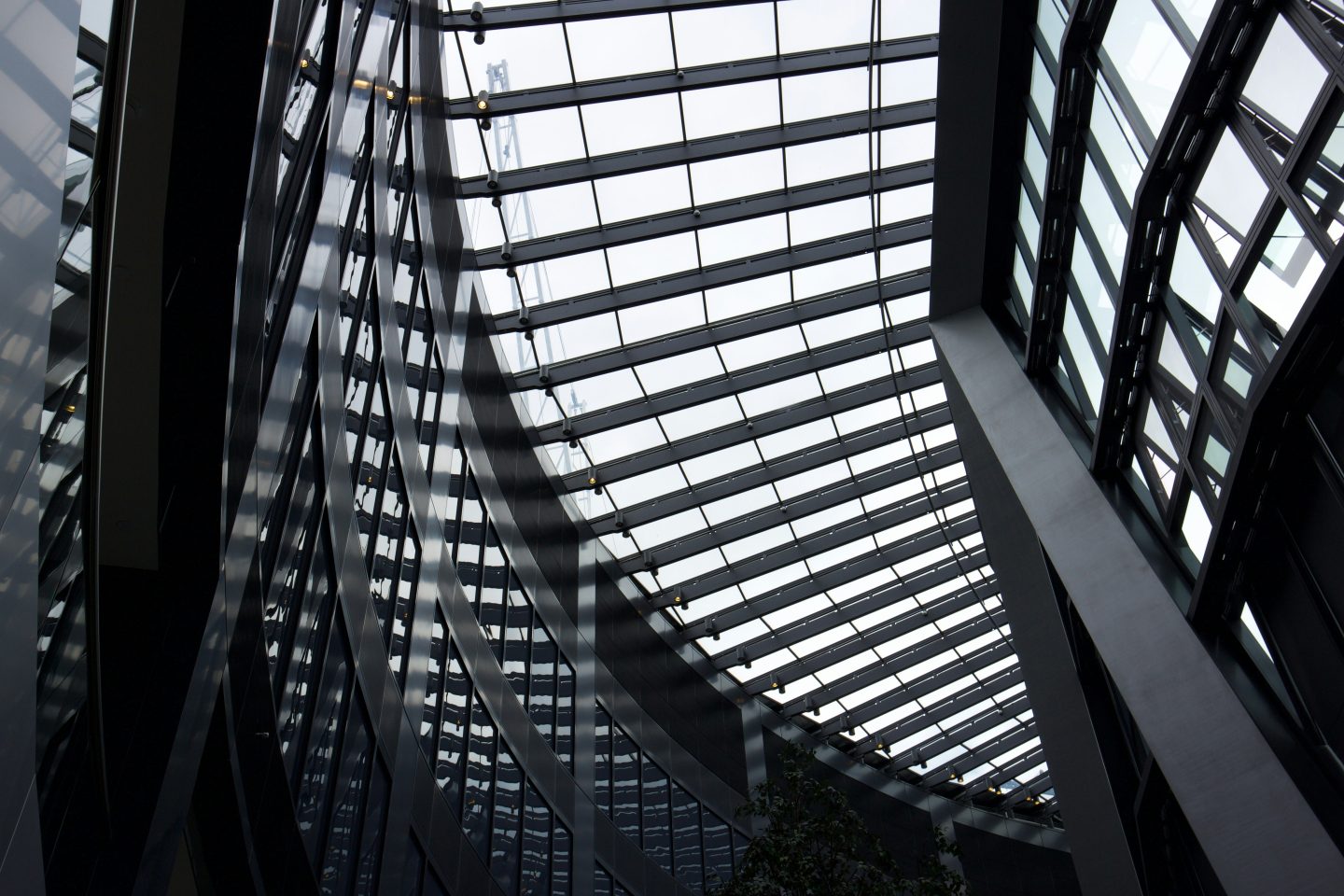 An abstract image of ceiling windows and steel pillars