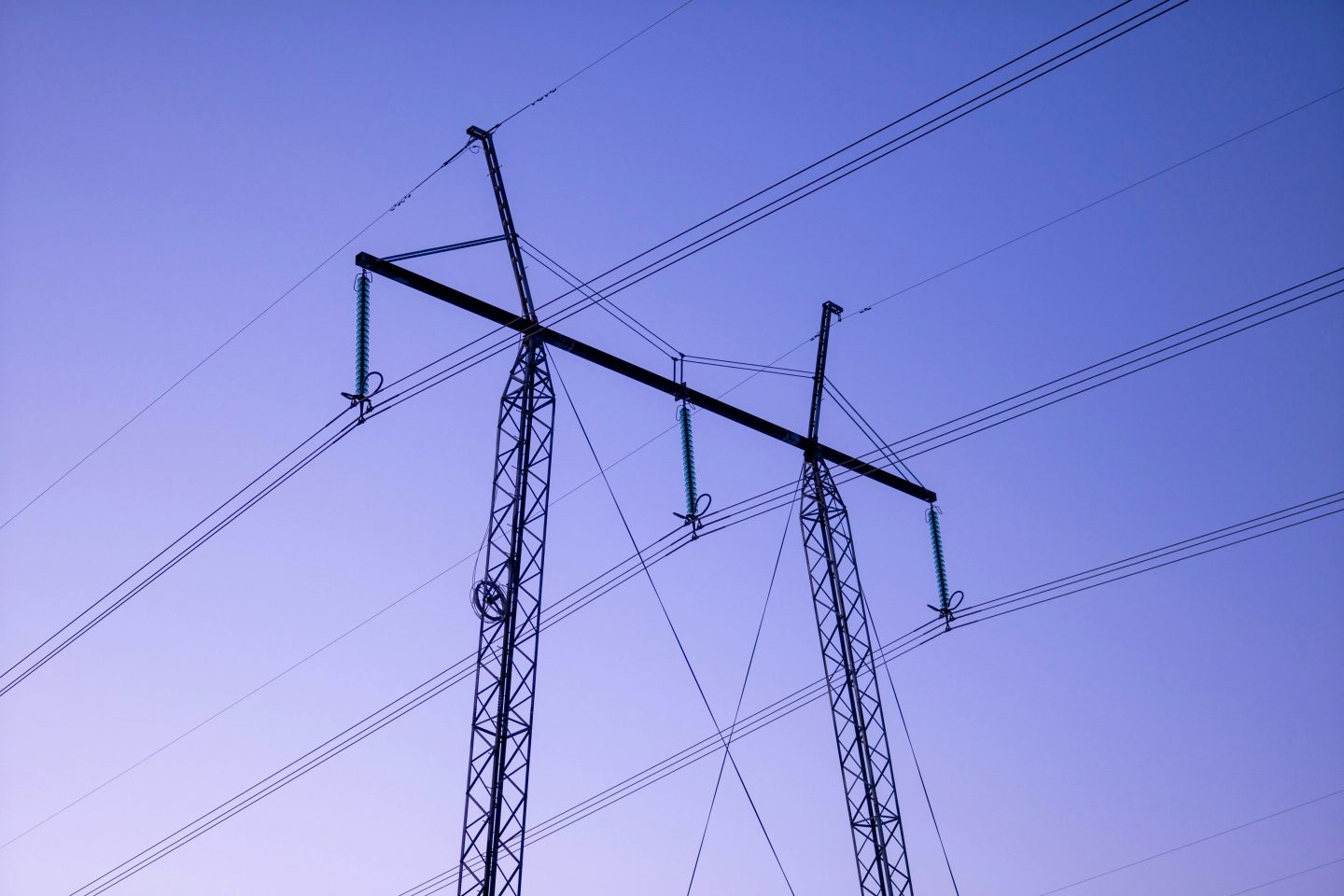 An electric tower against a dramatic purple sky