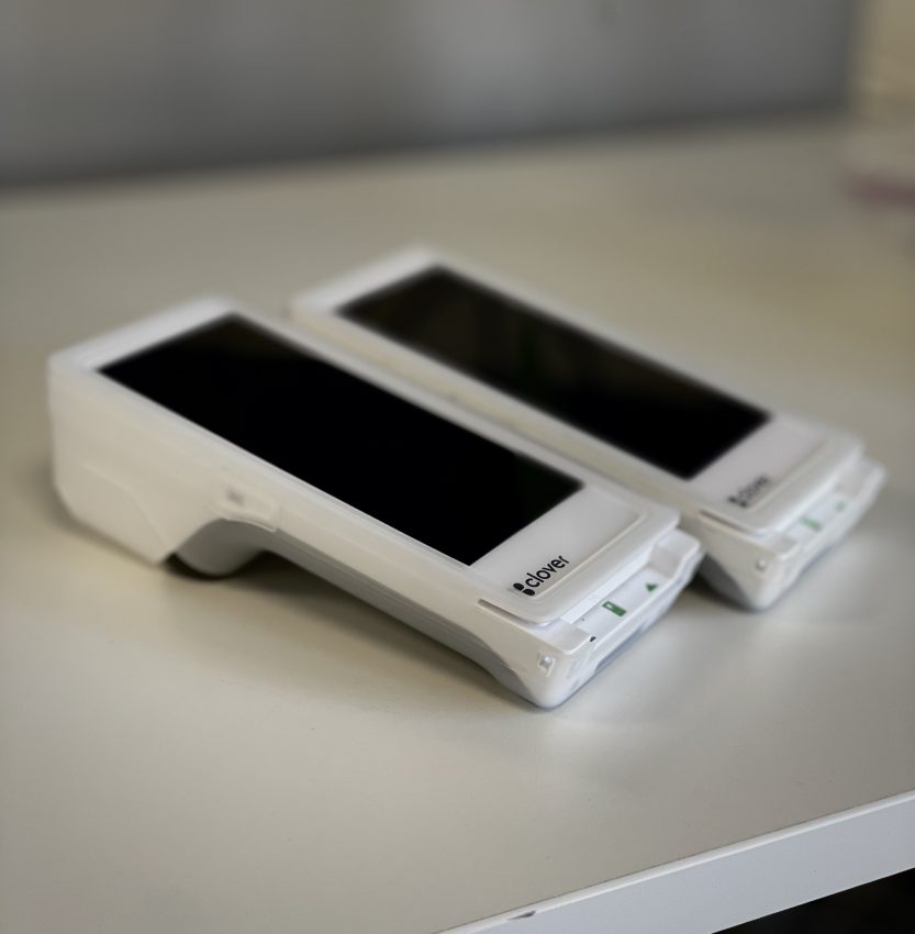 Two white, modern Clover terminals on a table