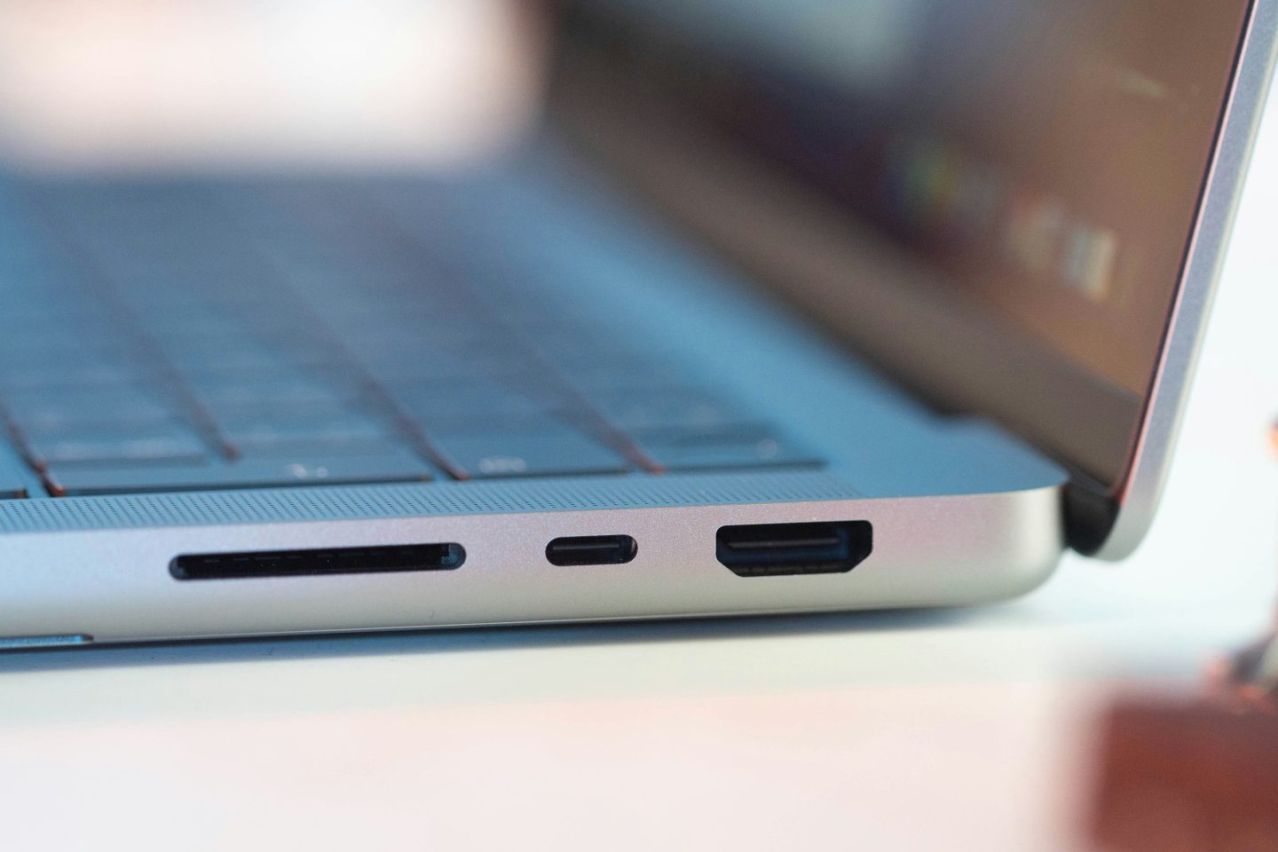 A close-up of a silver laptop, focusing on the USB ports.