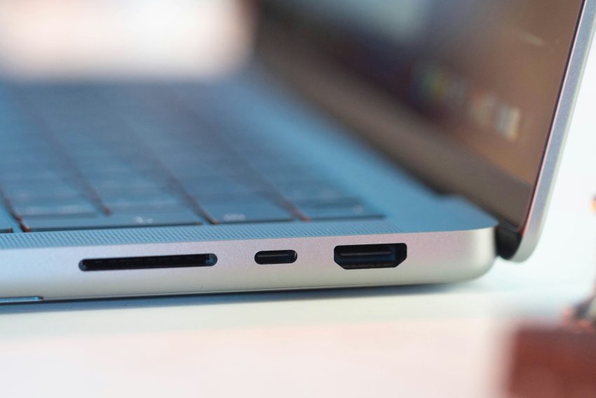 A close-up of a silver laptop, focusing on the USB ports.